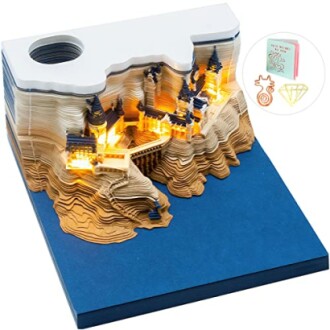 3D wooden puzzle book nook with illuminated castle design.