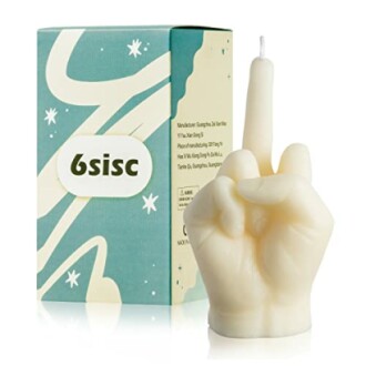 Candle shaped like a hand making a gesture, with packaging.