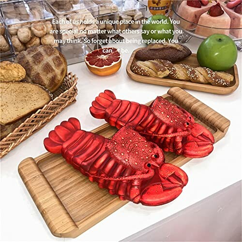 Lobster slippers on a wooden board surrounded by bread and fruit.