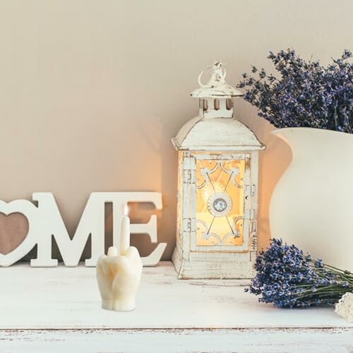 Rustic home decor with lantern, lavender, and a decorative candle.