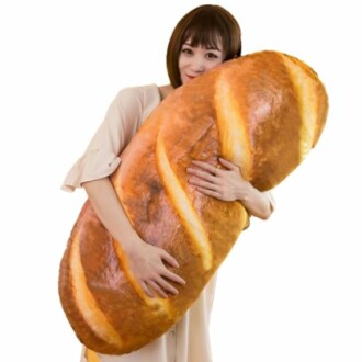 Woman hugging a giant loaf of bread.